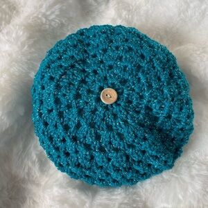 Turquoise beret with silver sparkles.